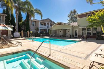 our apartments have a swimming pool and a patio with chairs